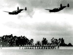 This WWII era photo shows two B-34s flying over a troop formation on the ground at Sonoma County Airport.