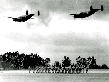 Photo of STS in 1942, showing U.S. Army soldiers and airplanes flying overhead.
